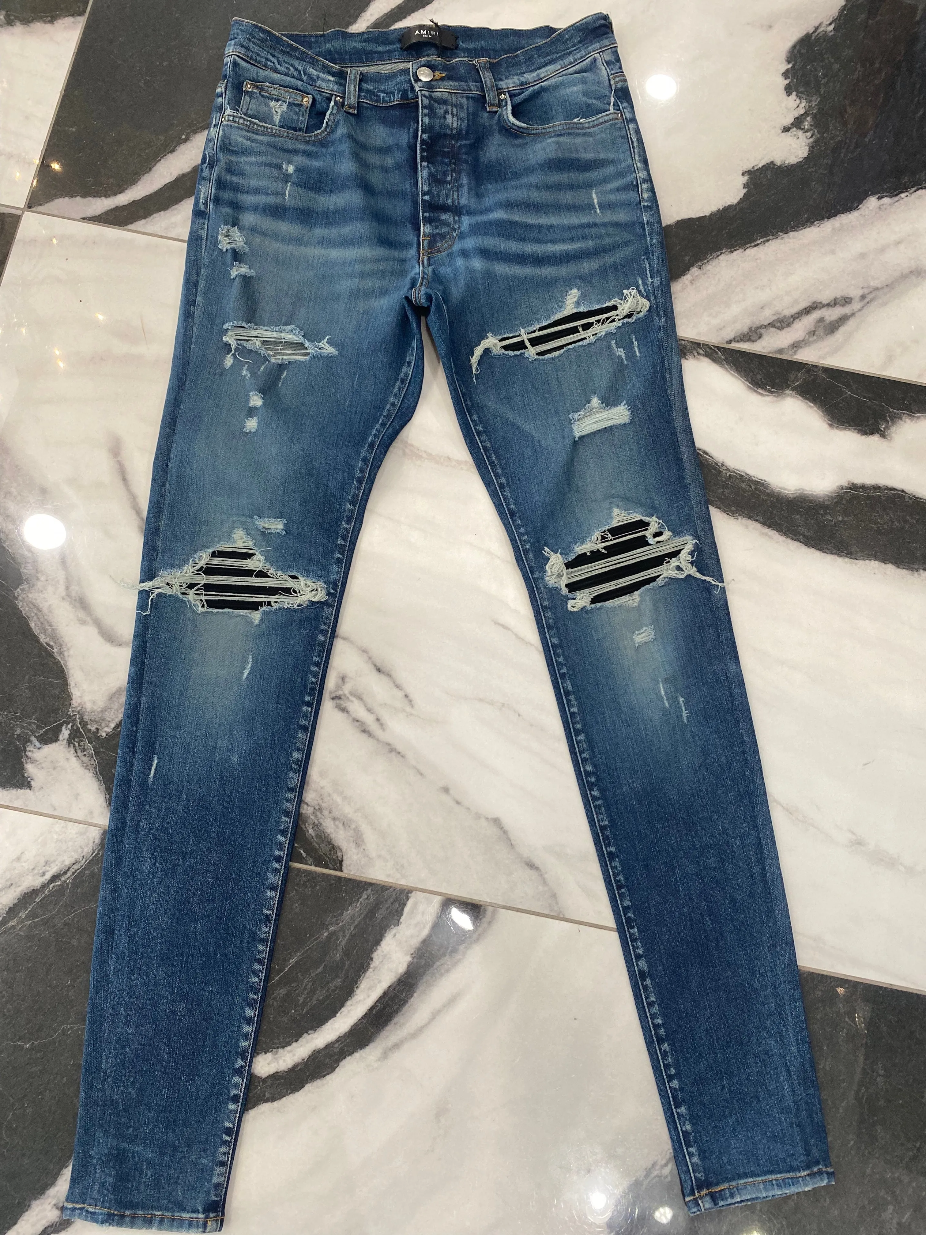 AMIRI MX1 DISTRESSED SKINNY LEG JEANS