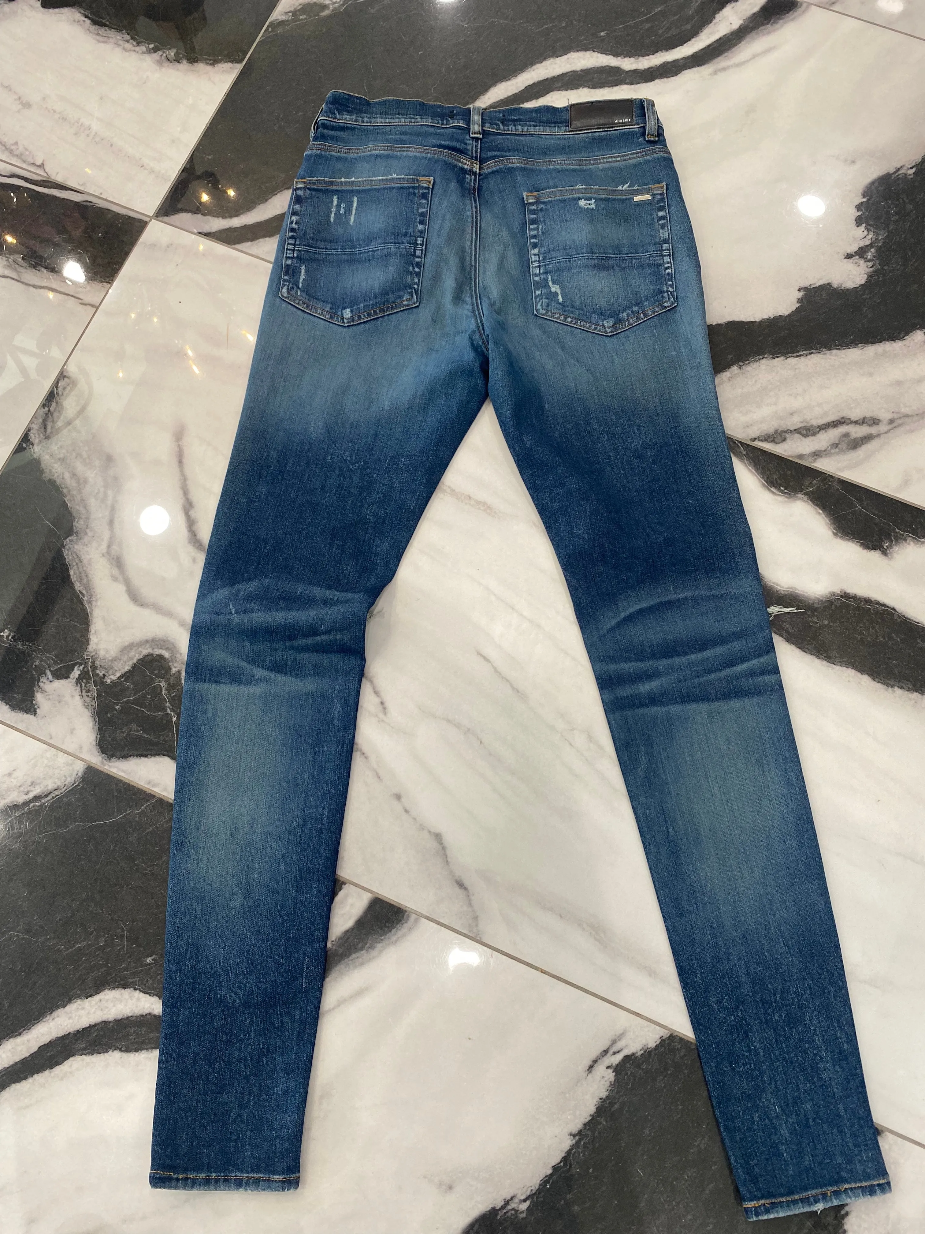 AMIRI MX1 DISTRESSED SKINNY LEG JEANS
