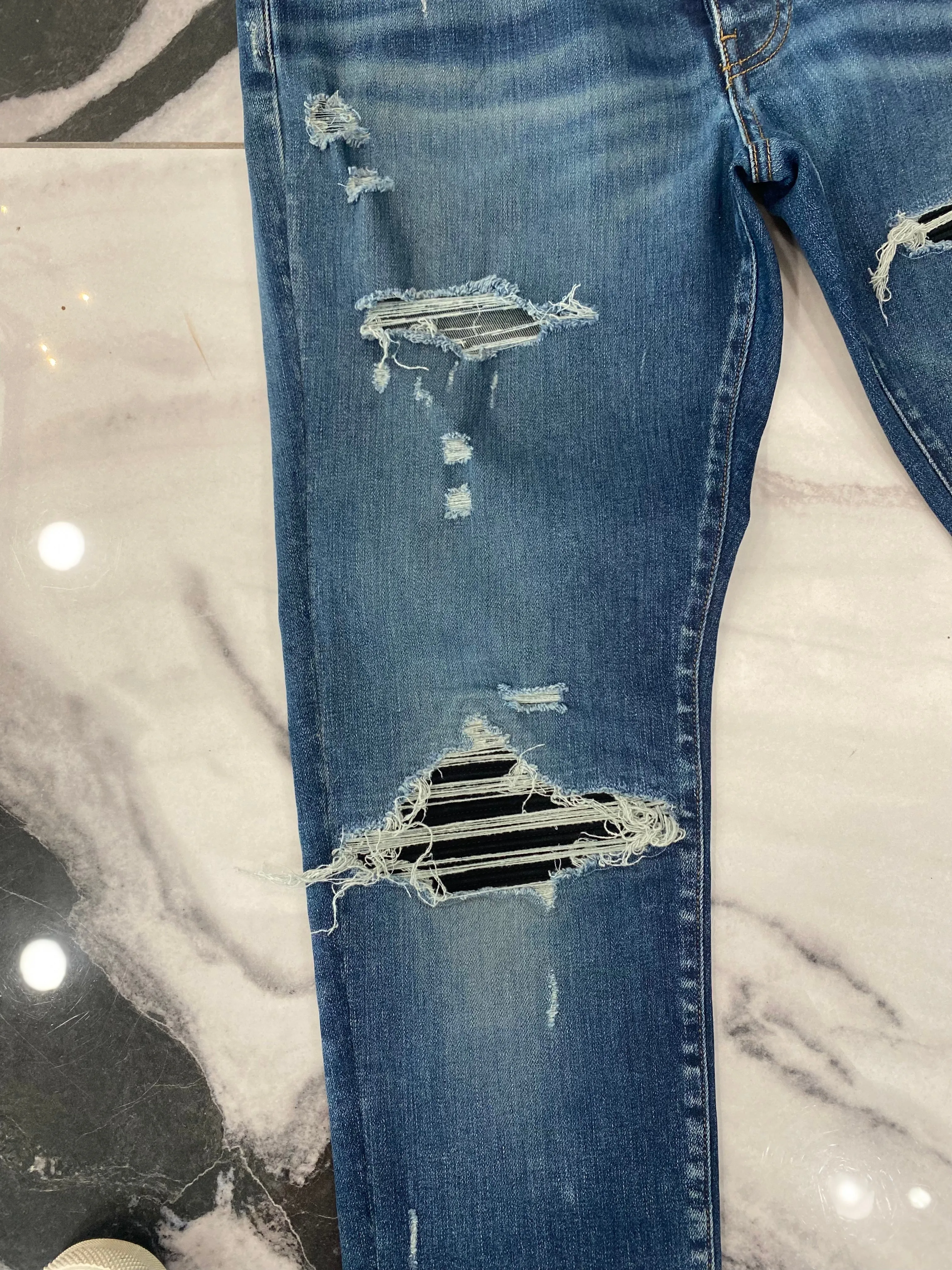 AMIRI MX1 DISTRESSED SKINNY LEG JEANS